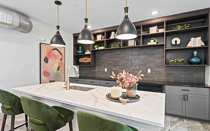 a kitchen with island and pendant lighting